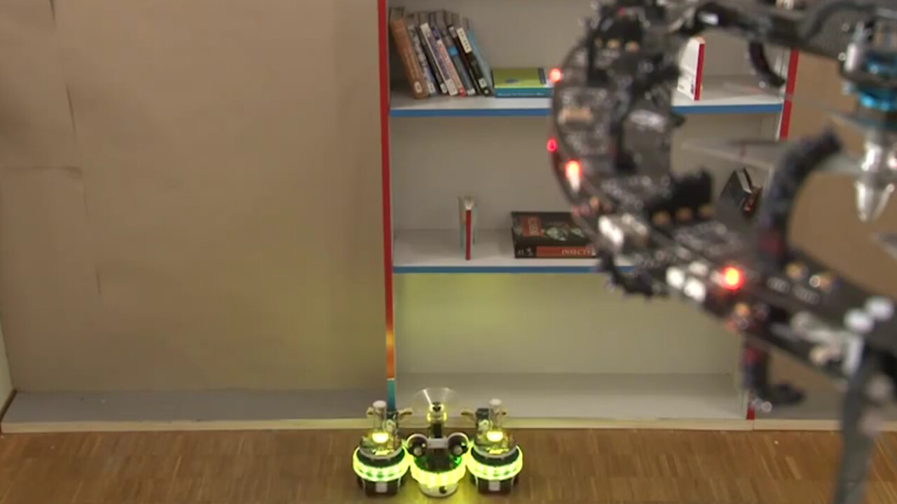 Award-winning Swarmanoid bots: Eye-bots, hand-bots, and foot-bots communicate to work together