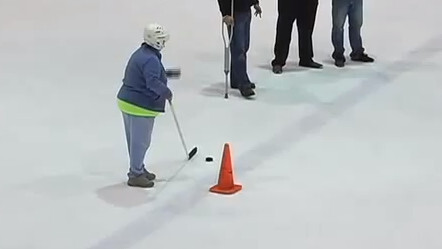 Watch this 59 year-old lady win a Ford truck with an insane hockey shot