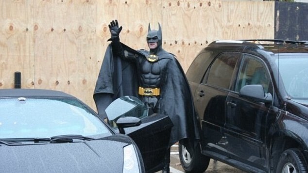 Batman gets pulled over by the police for not having a license plate on his Batmobile