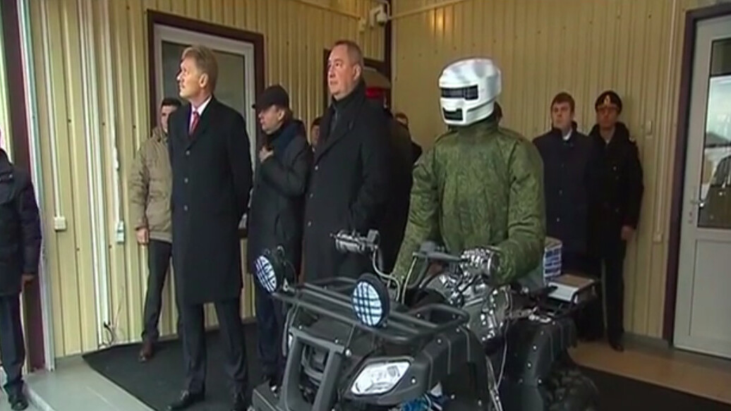 Russian President Vladimir Putin checks out military quad-riding robot